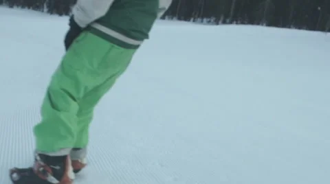 Snowboarder coming down on an empty snow-covered road Stock Footage 62539101