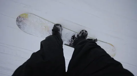 Snowboarder coming down on a snowboard Stock Footage 1060423