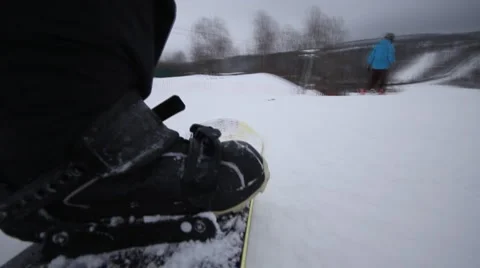 Snowboarder coming down on a snowboard Stock Footage 1060437