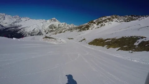 Snowboarder descends down the prepared slope. Dombay. FPV Stock Footage 74281524