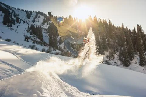 Snowboarder doing his trick method with nose grab Stock Photos