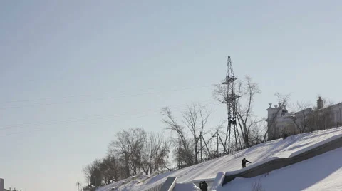Snowboarder doing a slide trick on a ledge in the street Stock Footage 64508456