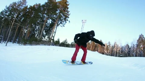 Snowboarder doing a stunt in the park Stock Footage 59556440