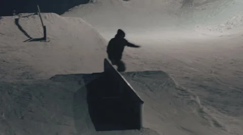 Snowboarder doing trick on the rail Stock Footage 64869760