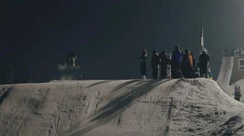 Snowboarder doing trick on the slope Stock Footage 64870137