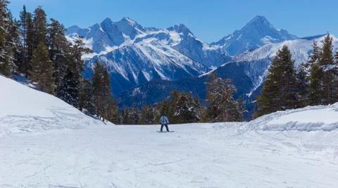 Snowboarder down the mountainside Stock Photos