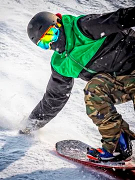 Snowboarder during a trick on a slope Stock Photos