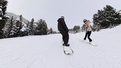 Snowboarder gliding down a snowy mountain slope Stock Footage 340789686