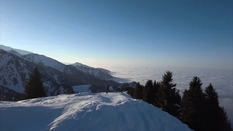 Snowboarder going down in the mountains, sunset Stock Footage 72175215