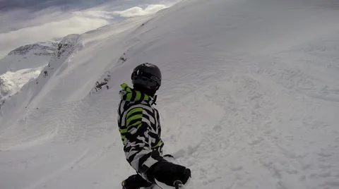 Snowboarder going down a slope through deep snow Video stock 50486983