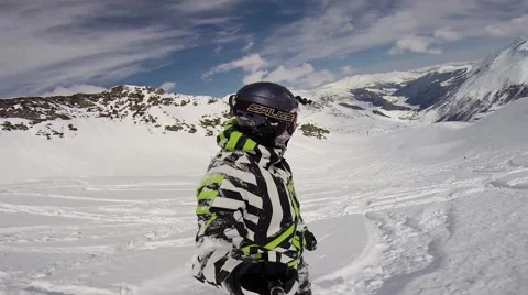 Snowboarder going down a slope through deep snow Stock Footage 50487048