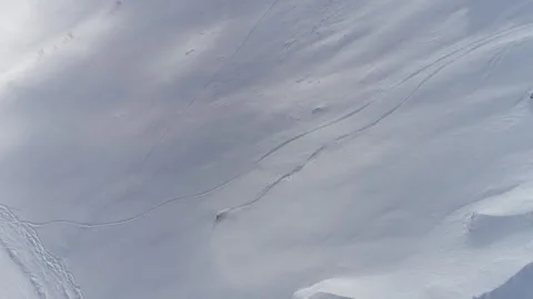 Snowboarder going down a snow-covered slope Stock Footage 241999721