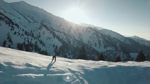 Snowboarder is jumping and going down Stock Footage 72174780