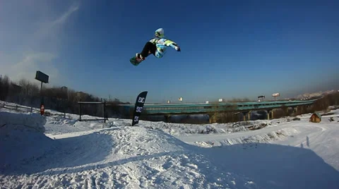 Snowboarder jumps trick Stock Footage 35498321