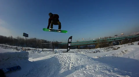 Snowboarder jumps trick Stock Footage 35498380