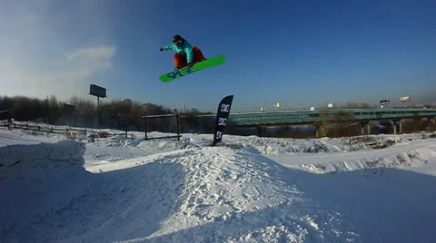 Snowboarder jumps trick Stock Footage 35498990