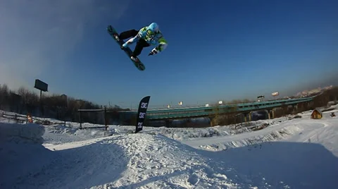 Snowboarder jumps trick Stock Footage 35499157