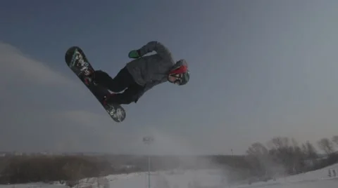 Snowboarder jumps trick Stock Footage 41235545