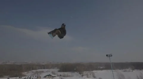 Snowboarder jumps trick Stock Footage 41235555
