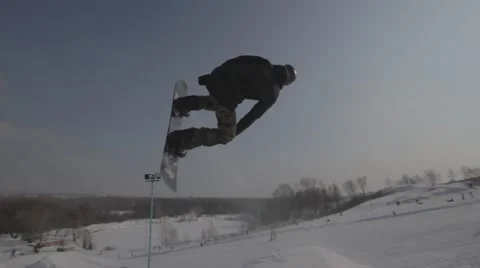 Snowboarder jumps trick Stock Footage 41235559