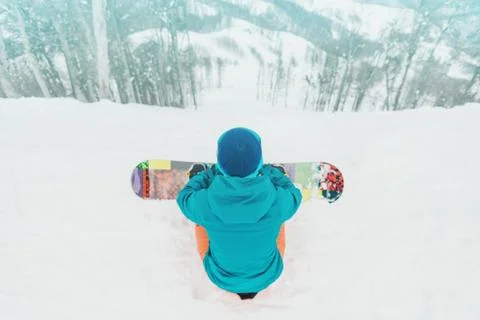 Snowboarder looking at slope Stock Photos