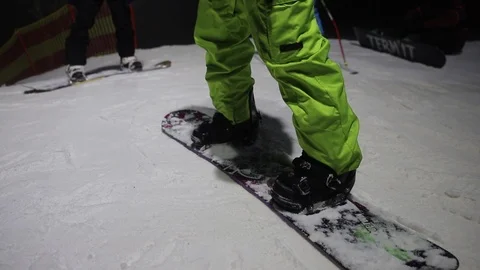 Snowboarder man rolls down the mountain in the evening Stock Footage 124005860