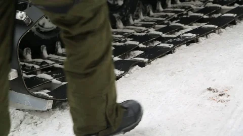 Snowboarder man sitting on the technique of winter dress boots Stock-Footage 73673203