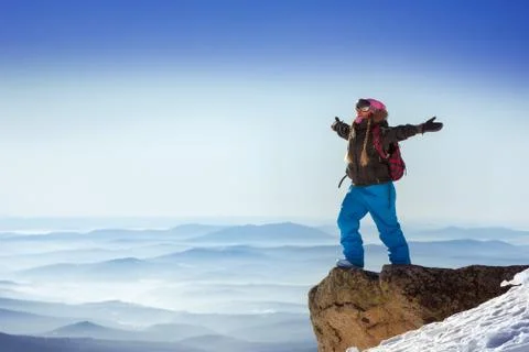 Snowboarder posing on blue sky backdrop in mountains skiing Stock Photos