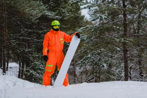Snowboarder posing in winter forest Stock Photos
