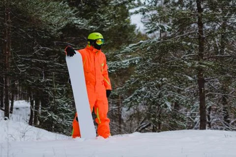 Snowboarder posing in winter forest Stock Photos