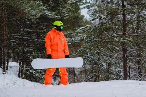 Snowboarder posing in winter forest Stock Photos