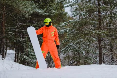 Snowboarder posing in winter forest Stock Photos