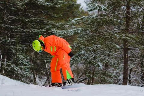 Snowboarder posing in winter forest Stock Photos