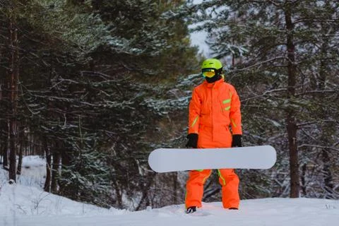 Snowboarder posing in winter forest Stock Photos