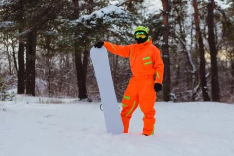 Snowboarder posing in winter forest Stock Photos
