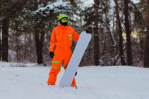 Snowboarder posing in winter forest Stock Photos