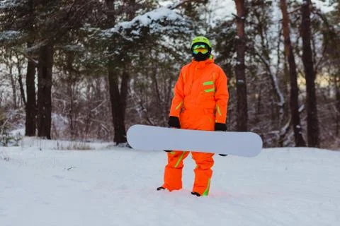 Snowboarder posing in winter forest Stock Photos
