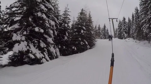 Snowboarder POV while getting pulled uphill by ski lift Stock Footage 85274270