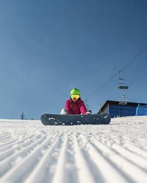 Snowboarder preparing for an exciting descent on a pristine snow-covered slope Stock Photos