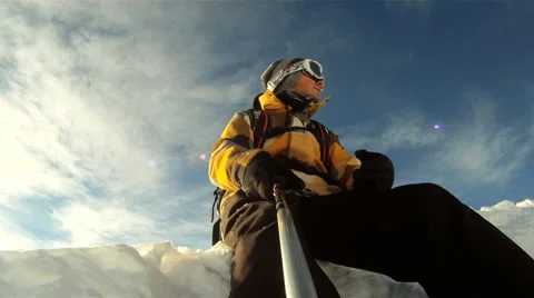 Snowboarder relaxing in the sun Stock Footage 3148880