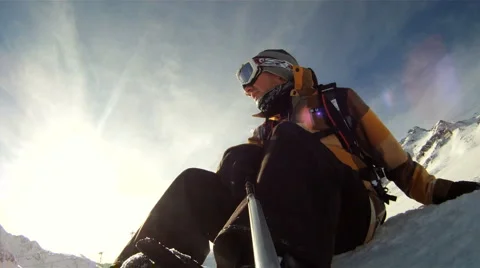 Snowboarder relaxing in the sun Stock Footage 3274760