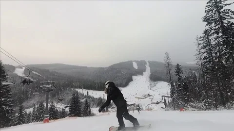 Snowboarder rides and falls down into snow Video stock 122821767