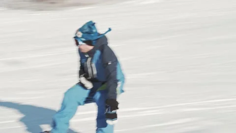A snowboarder rides down from hill at high speed. Snow sprays in all directions Stock Footage 158744880