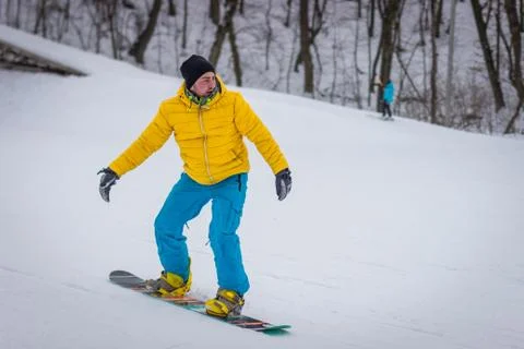 Snowboarder rides on mountain slope on snow winter Stock Photos