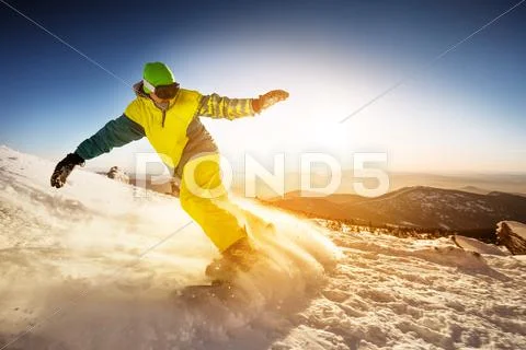 Snowboarder Rides On The Slope Snow Mountains Background