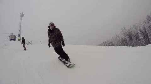 Snowboarder riding down the mountain Stock Footage 64508957