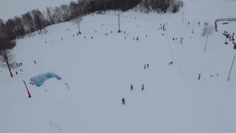 A snowboarder rolls down the slope of a ski complex Stock Footage 170259798