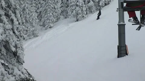Snowboarder shredding down slope Stock Footage 58653051
