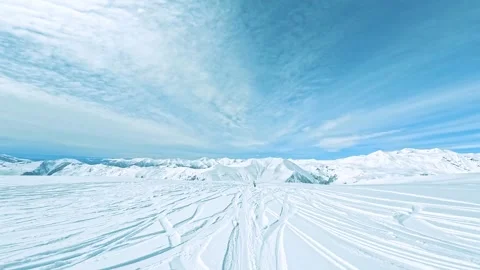 Snowboarder Skiing Down Freeride Mountain and Powder, Bluebird day, Wide Shot Stock Footage 307972540