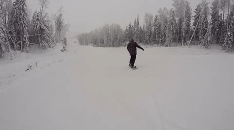 A snowboarder slides down from the snowpark Stock Footage 64509040